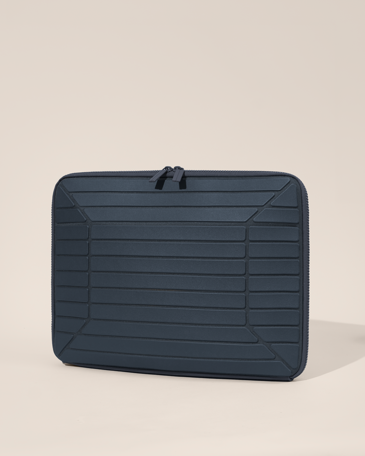 Closed Afform 15" Indigo (navy) Laptop Case closed, exterior view showing structured horizontal bar detail and zipper closure