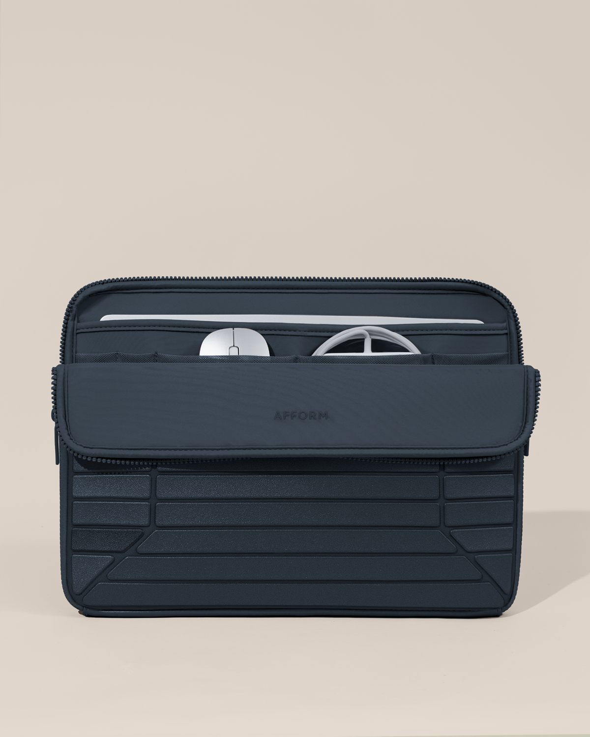 Afform 15" Indigo (navy) Laptop Case partially open, fold-down front panel revealing a laptop in the neoprene sleeve and mesh pockets with a mouse and charger, structured horizontal bar detail on exterior