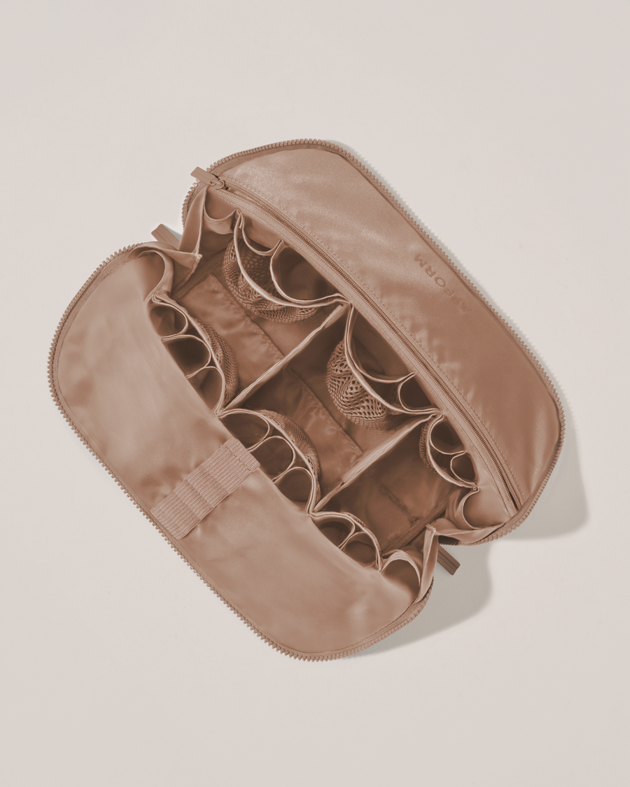Interior view of Afform Large Bronze Traveller makeup bag showing empty pockets, pouches, elastic holders, and zipper pocket for loose items