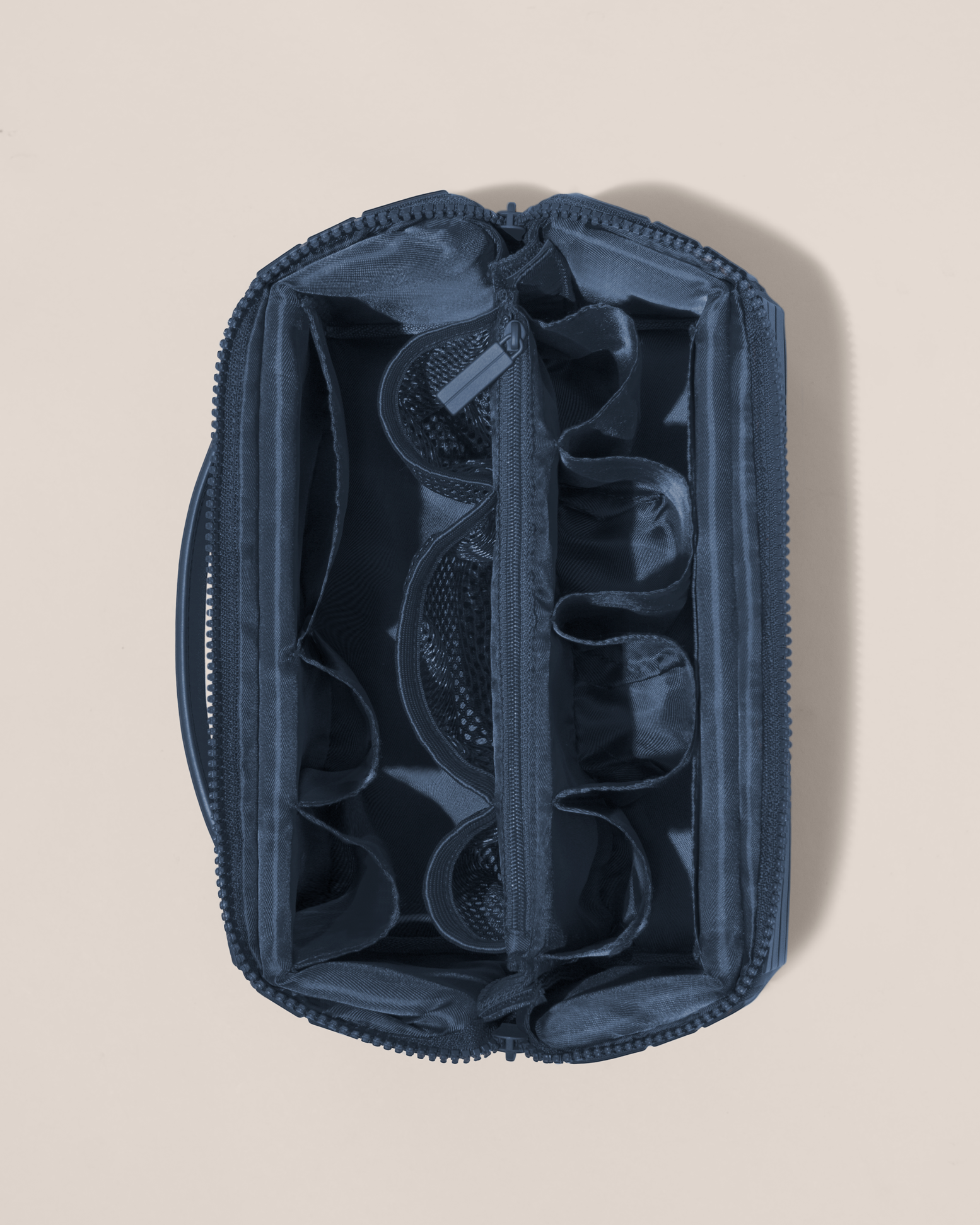 Overhead view of Afform Large Indigo (blue) Kit toiletry bag, showcasing its structured interior with multiple compartments and mesh pockets for organized travel storage