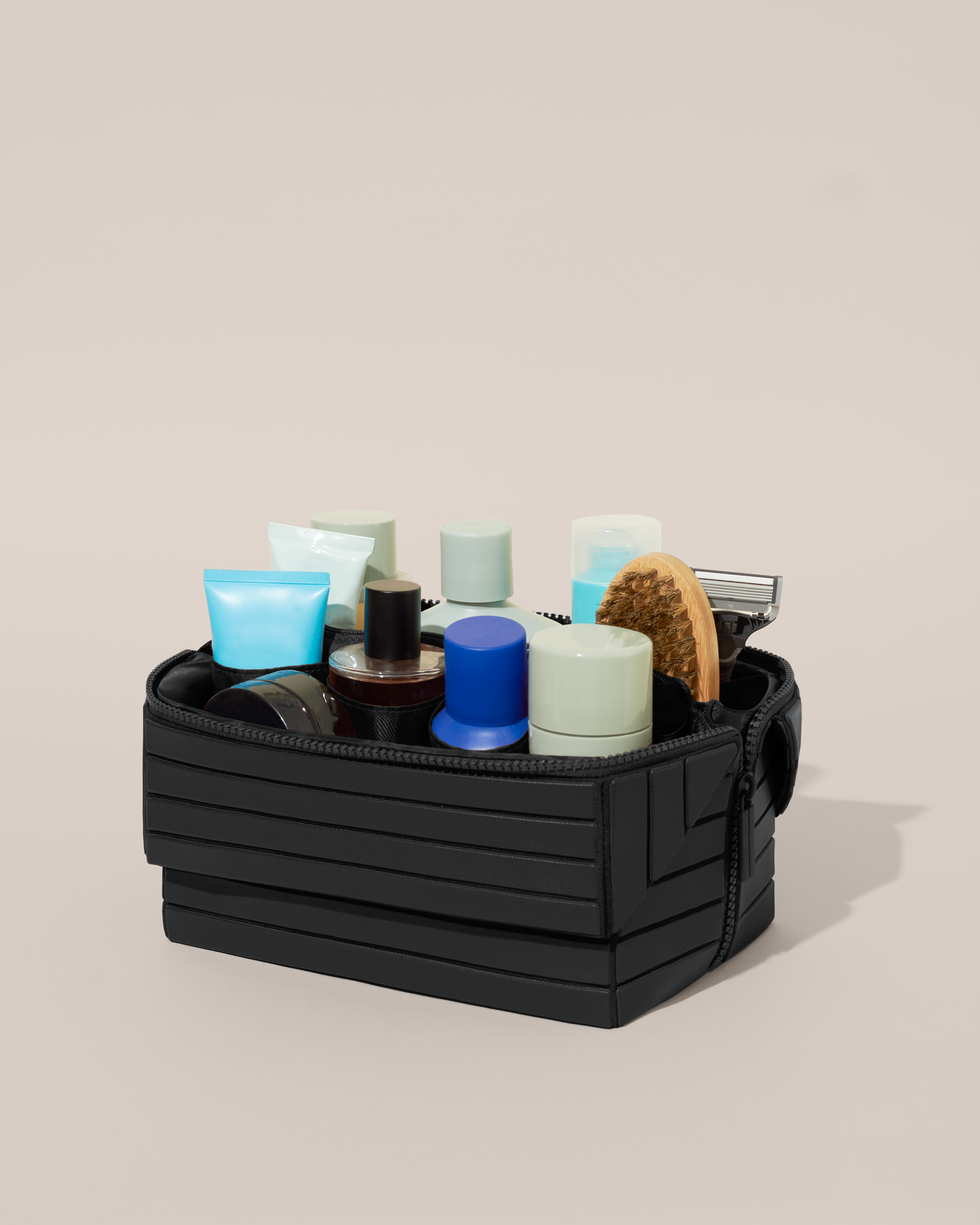 Open Afform Onyx (black) Kit, shown open and packed with grooming essentials like razors, cologne, and skincare. A structured, travel-ready toiletry organizer