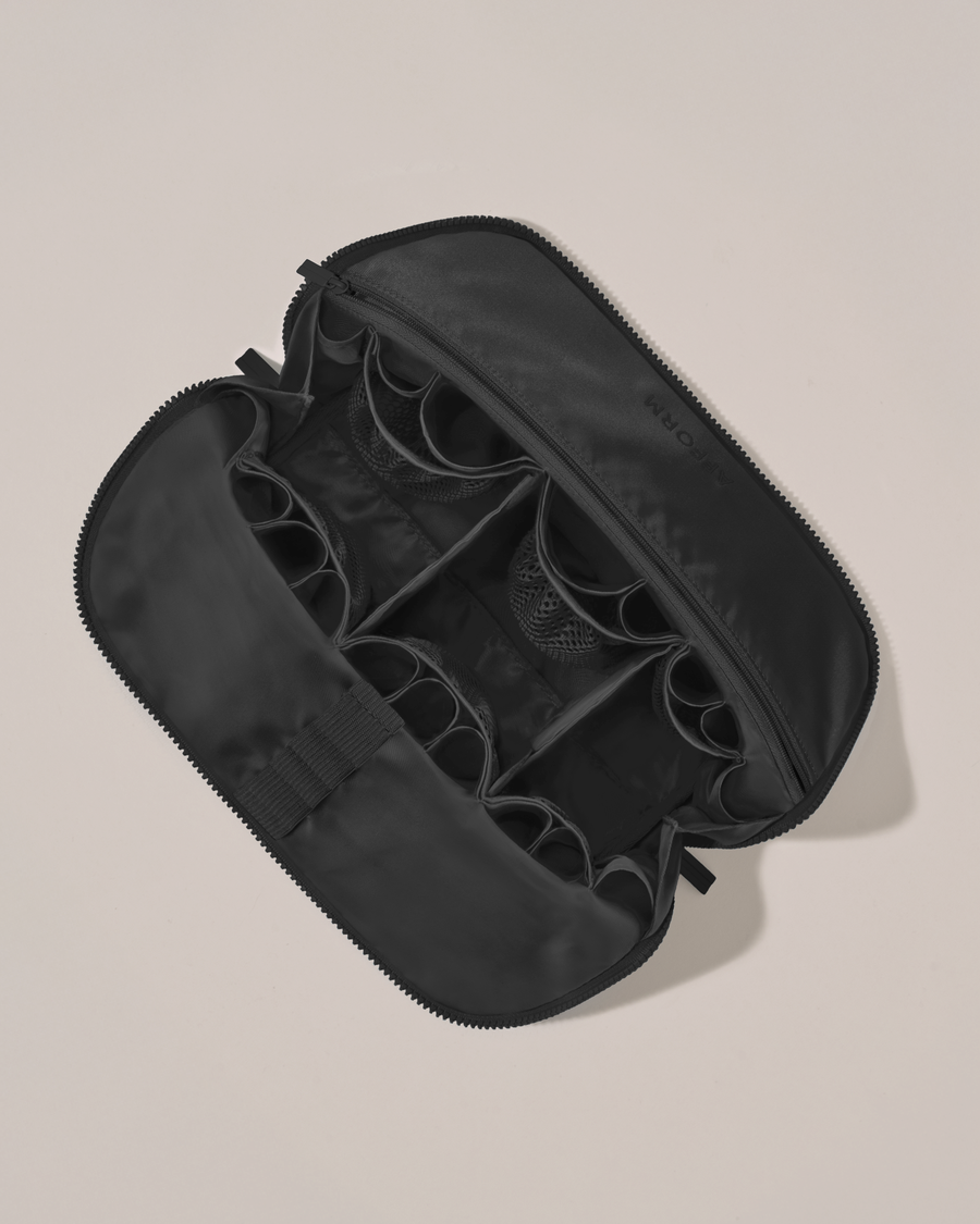 Interior view of Afform Large Onyx (black) Traveller makeup bag showing empty pockets, pouches, elastic holders, and zipper pocket for loose items