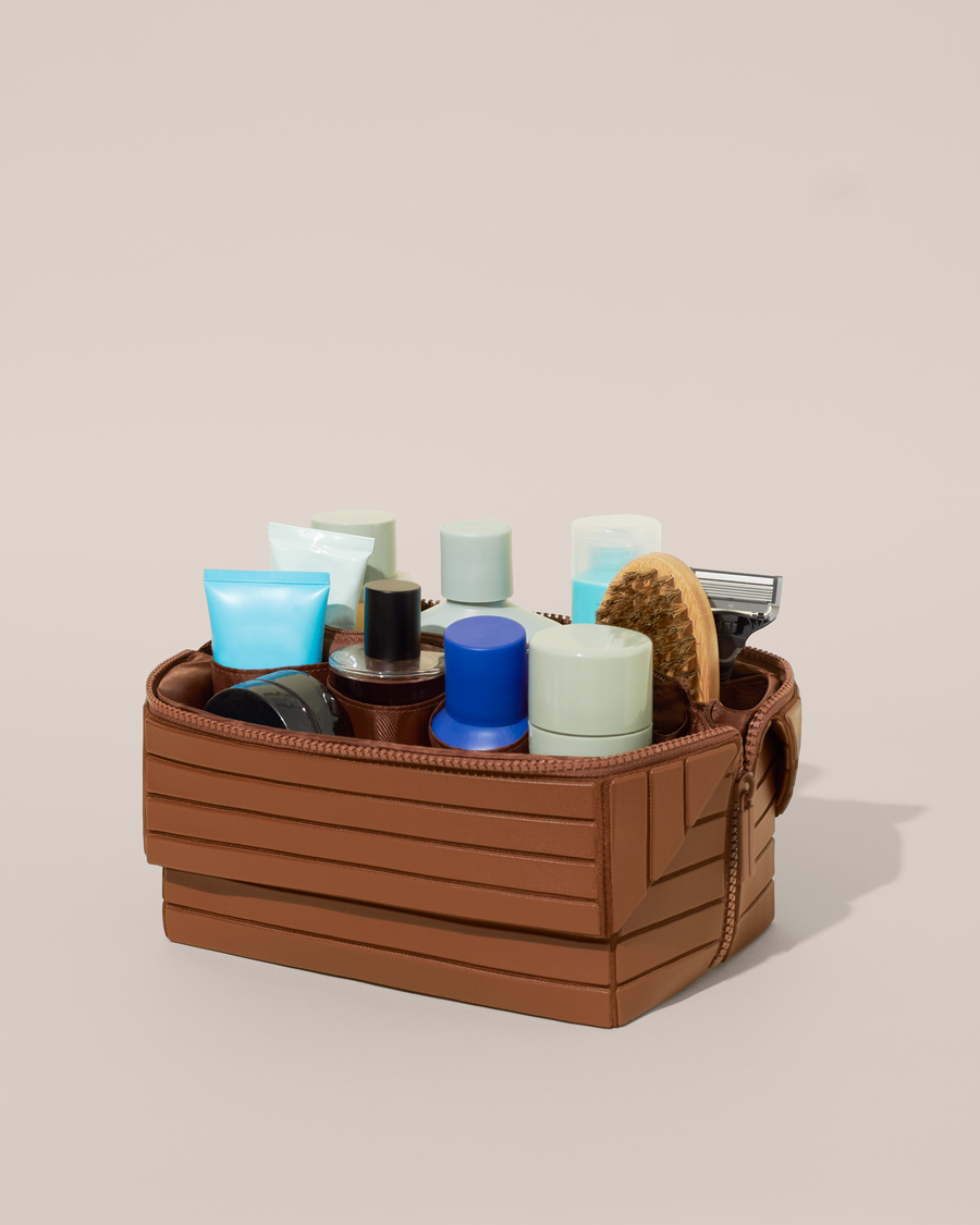 Open Afform Large Vicuna (brown) Kit, shown open and packed with grooming essentials like razors, cologne, and skincare. A structured, travel-ready toiletry organizer