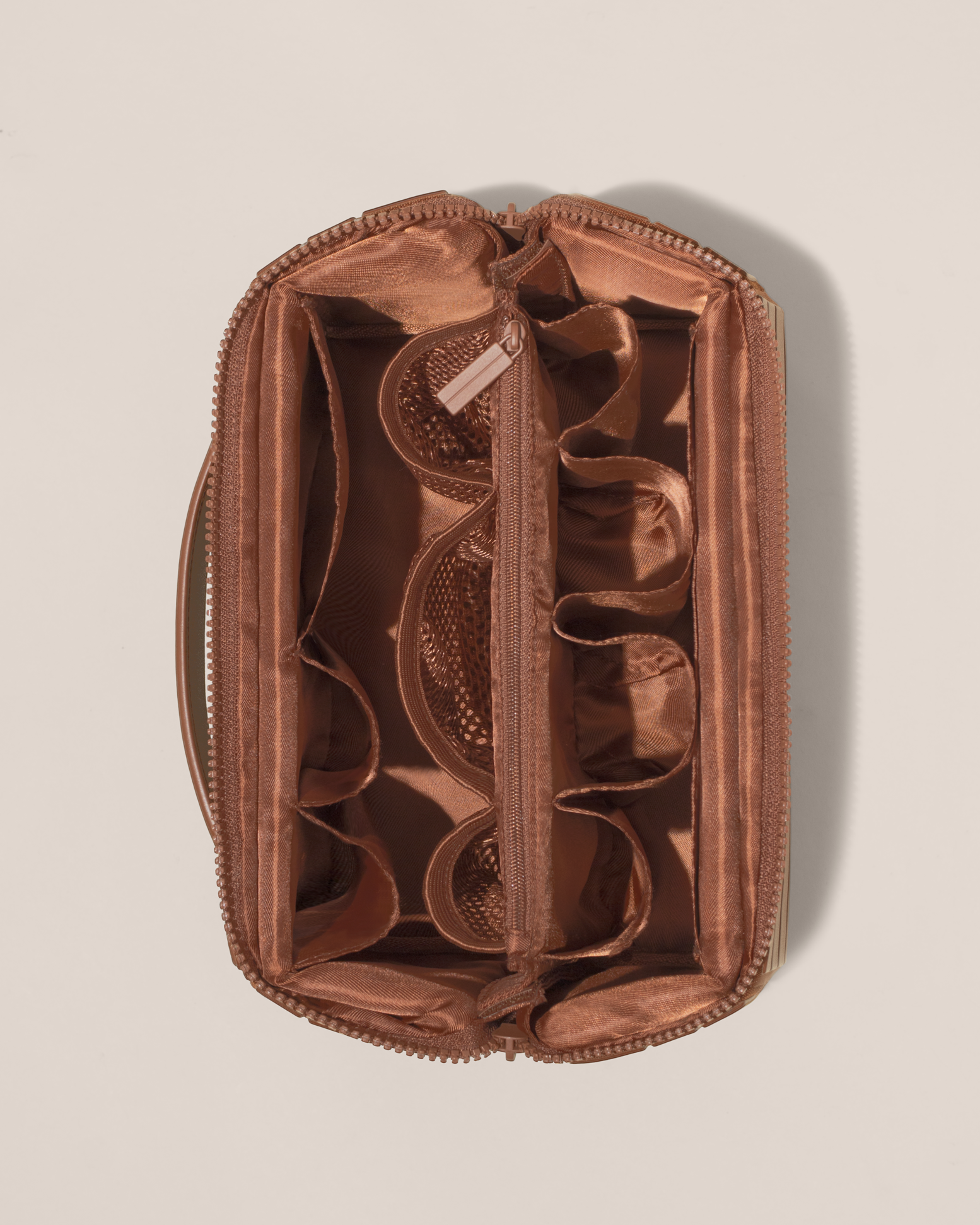 Overhead view of Afform Large Vicuna (brown) Kit toiletry bag, showcasing its structured interior with multiple compartments and mesh pockets for organized travel storage