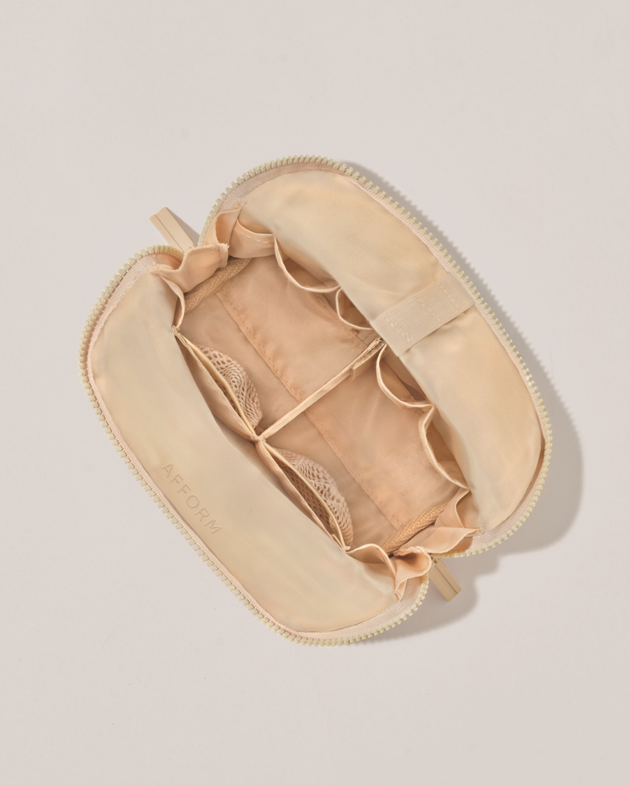 Interior view of Afform Small Bisque (white) Traveller makeup bag showing empty pockets, pouches, and elastic holders
