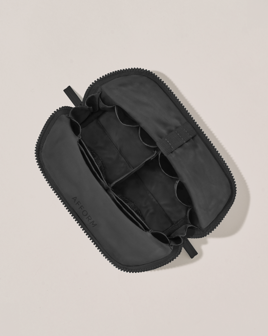 Interior view of Afform Small Onyx (black) Traveller makeup bag showing empty pockets, pouches, and elastic holders
