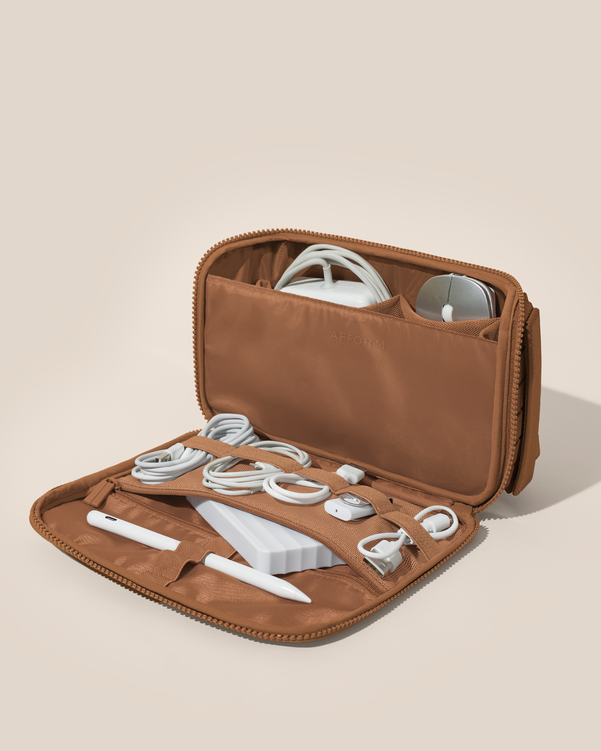 Afform vicuna (brown) Tech Kit electronics organizer shown open and packed with a laptop charger, mouse, phone charger, USB drive, stylus, and more