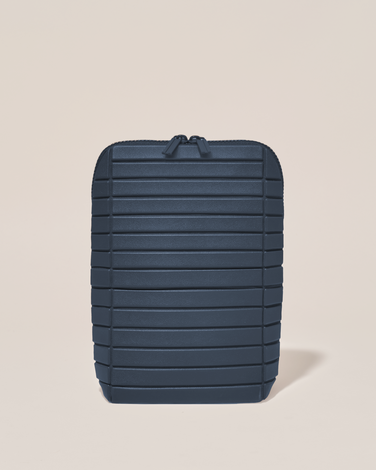 Closed Parallelle Indigo (navy) Brush Traveller makeup bag with structured horizontal bar design