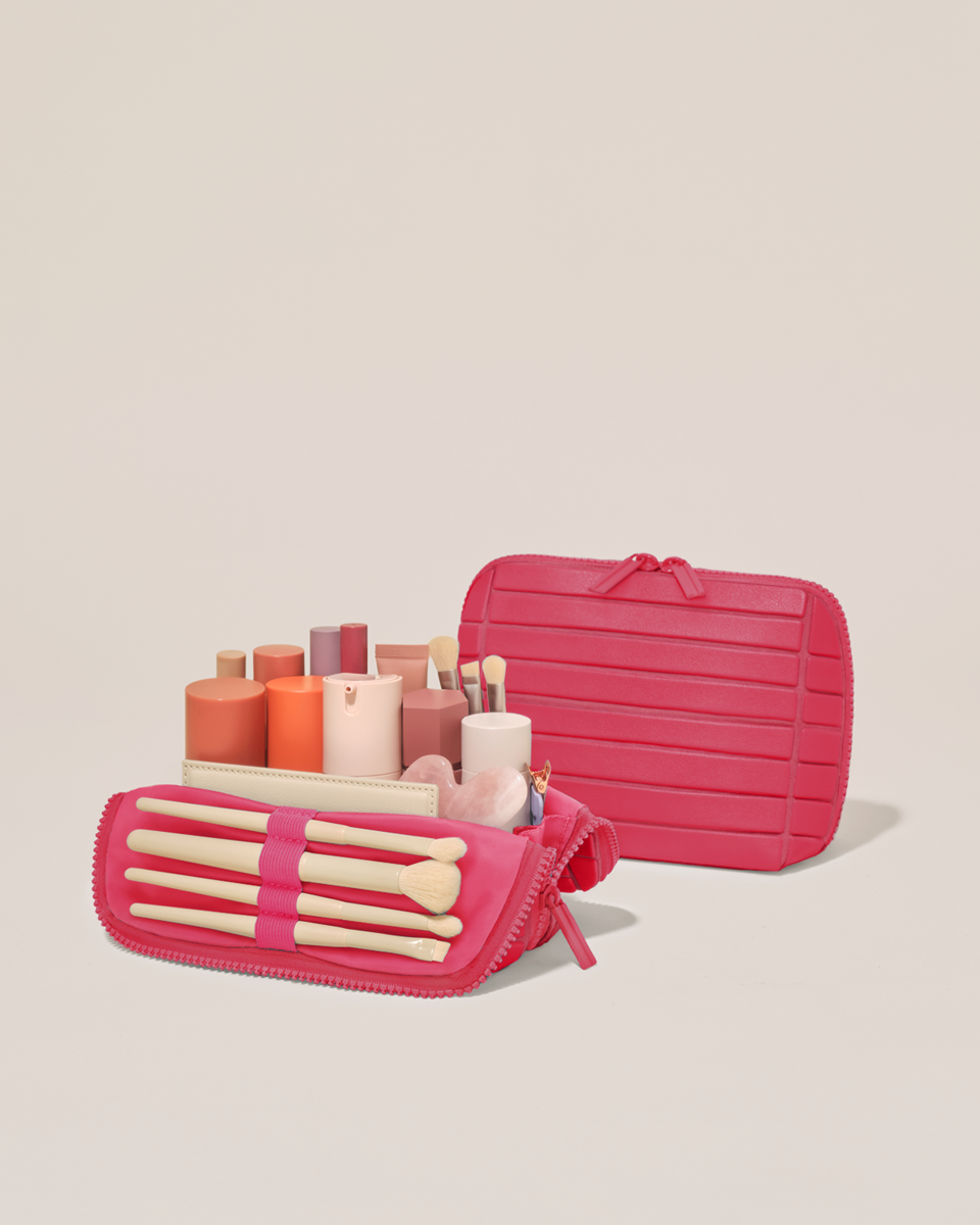 Open and closed Parallelle Small Tart (hot pink) Traveller makeup bag showing skincare, brushes, and curated travel essentials