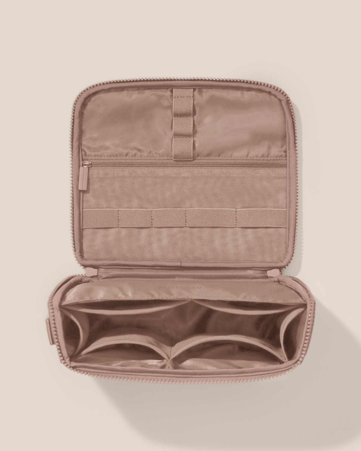 Overhead view of the Afform bronze Tech Kit electronics organizer, showcasing its 8 elastic loops, 6 mesh pockets, and 1 zipper pocket on the upper panel and a structured lower compartment with dividers