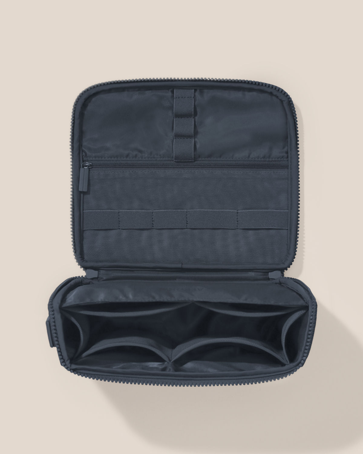 Overhead view of the Afform Indigo (navy) Tech Kit electronics organizer, showcasing its 8 elastic loops, 6 mesh pockets, and 1 zipper pocket on the upper panel and a structured lower compartment with dividers