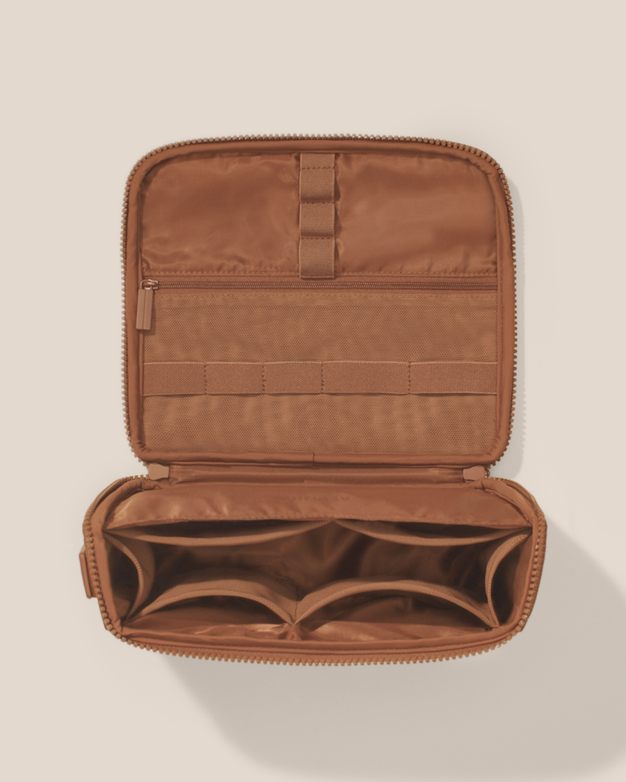 Overhead view of the Afform vicuna (brown) Tech Kit electronics organizer, showcasing its 8 elastic loops, 6 mesh pockets, and 1 zipper pocket on the upper panel and a structured lower compartment with dividers