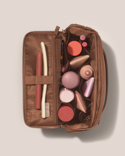 Image of the medium kit top down, open with an assortment of toiletries inside of it.