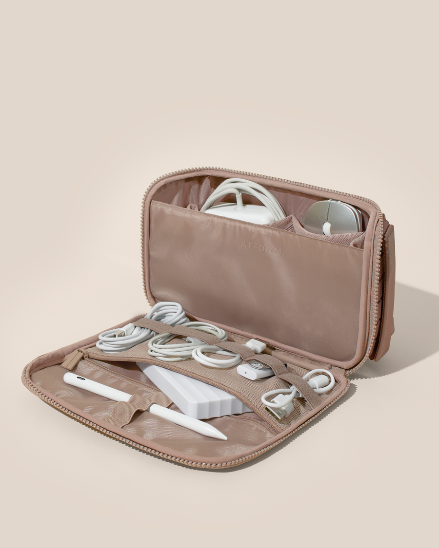 Afform bronze Tech Kit electronics organizer shown open and packed with a laptop charger, mouse, phone charger, USB drive, stylus, and more