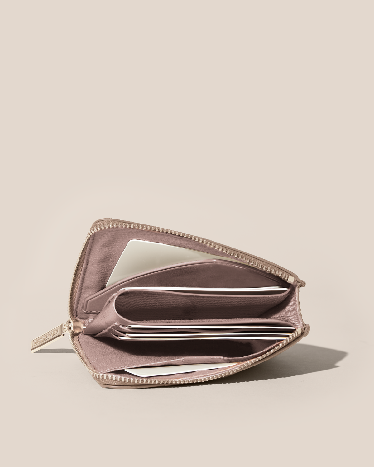 Fully open Afform Bronze Zip Wallet showing multiple card slots and a full-length bill compartment