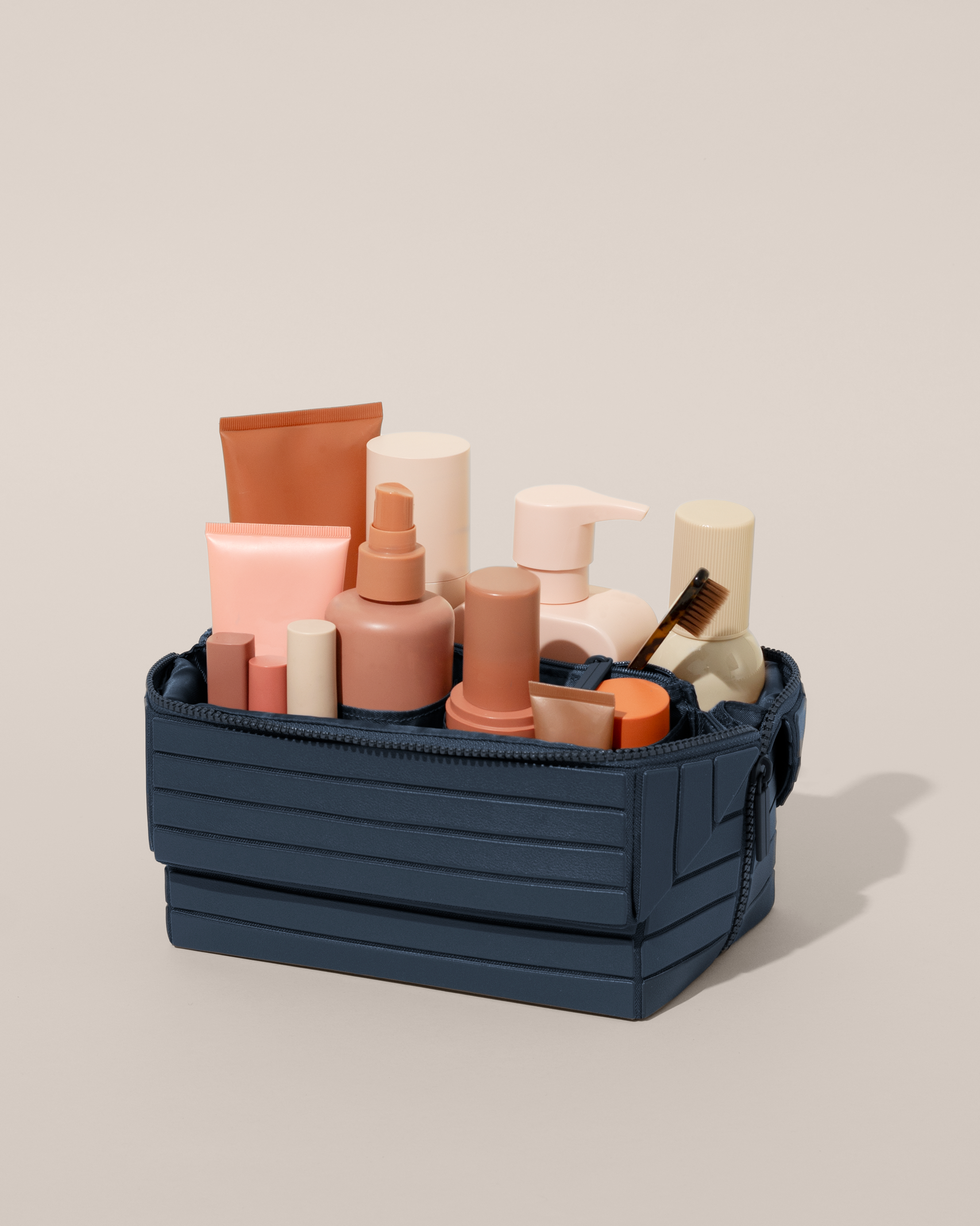 Open Afform Indigo (blue) Kit, shown open and packed with skincare and grooming products. A compact, structured toiletry bag designed for visibility and access.