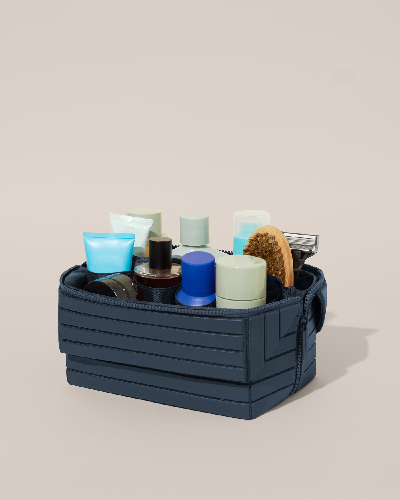 Open Afform Large Indigo (blue) Kit, shown open and packed with grooming essentials like razors, cologne, and skincare. A structured, travel-ready toiletry organizer