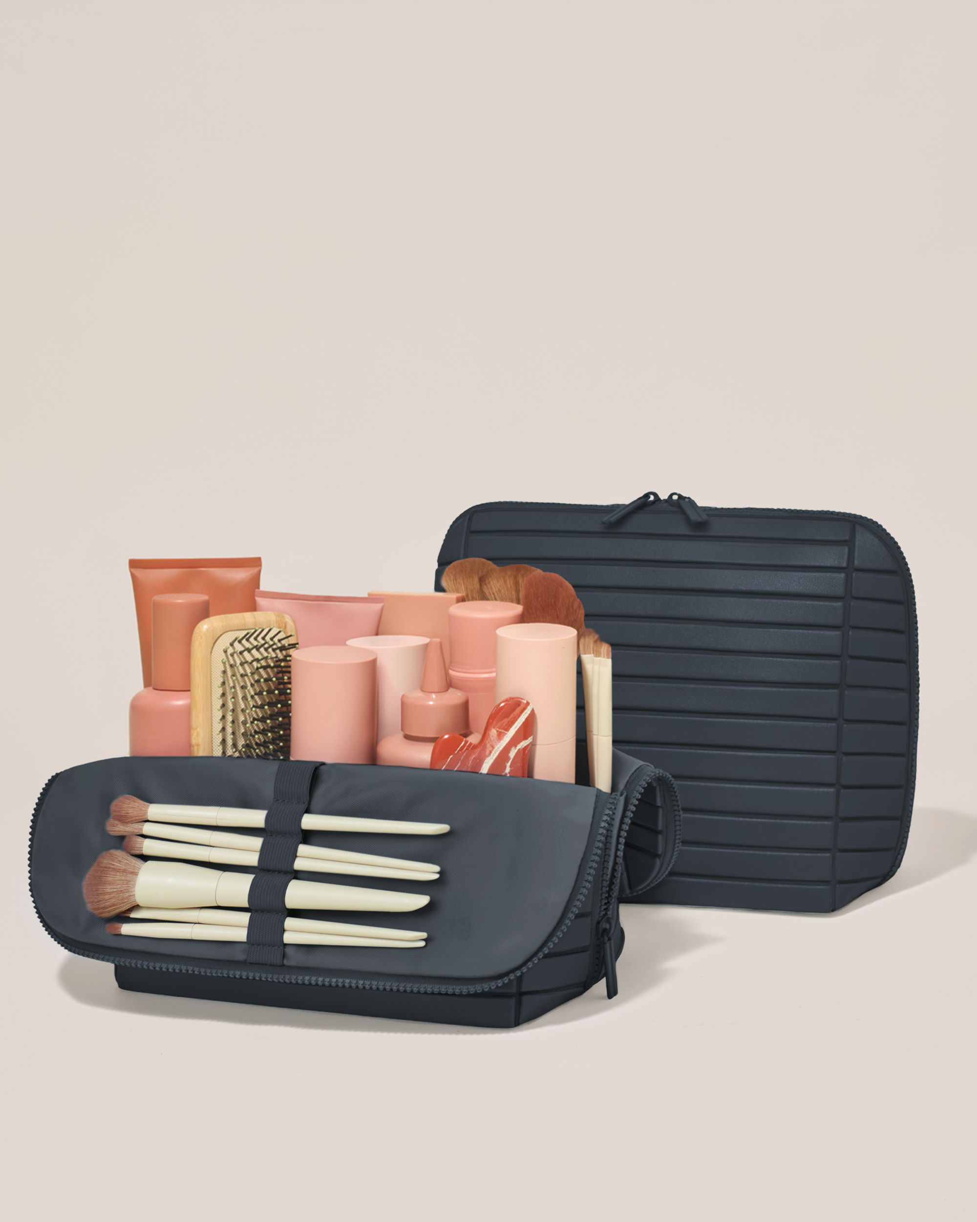 Open and closed Afform Large Indigo (navy) Traveller makeup bag showing skincare, brushes, and curated travel essentials