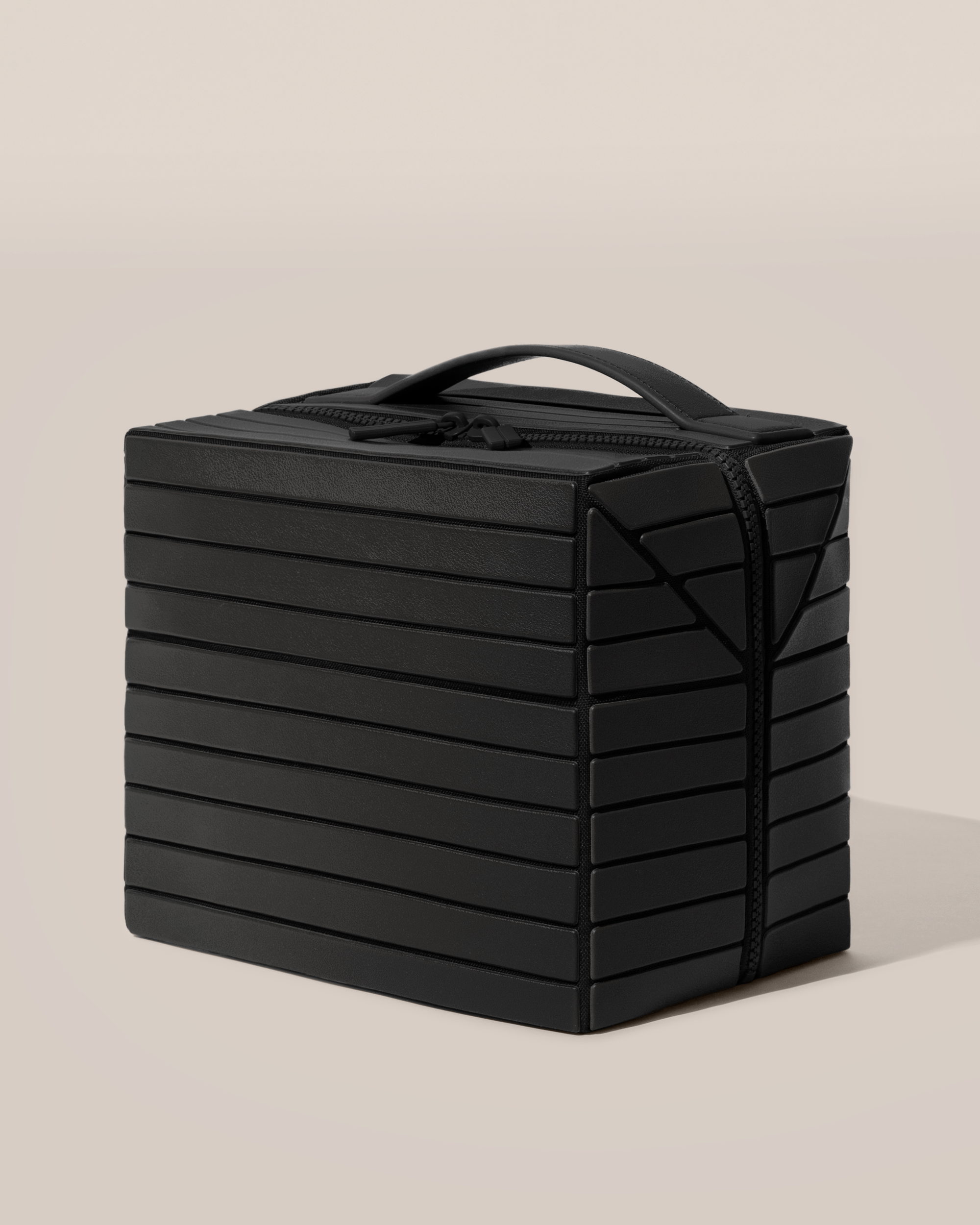 Side view of the closed Afform Onyx (black) Kit toiletry bag with a compact, zip-around design and top handle for elevated everyday or travel organization