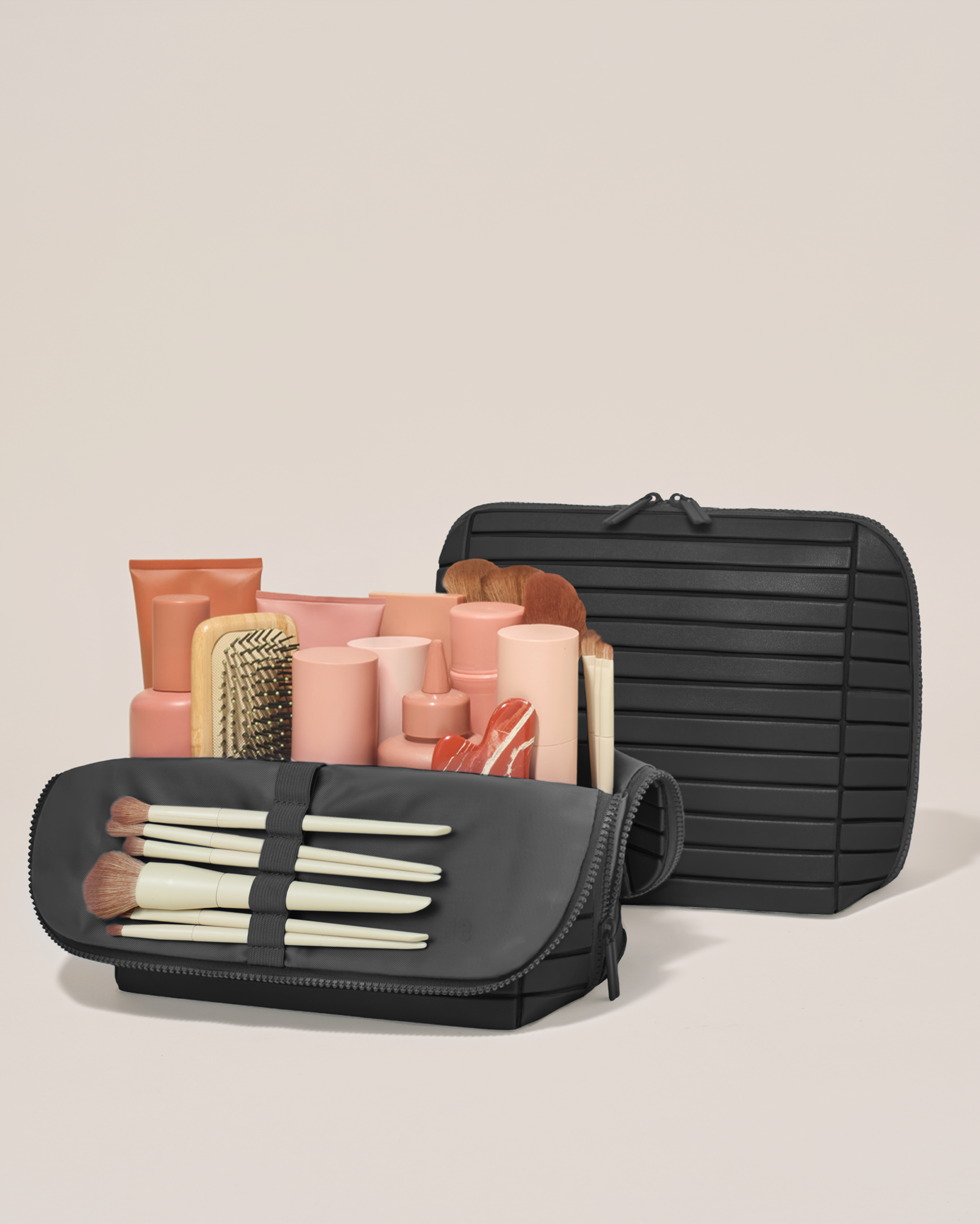 Open and closed Afform Large Onyx (black) Traveller makeup bag showing skincare, brushes, and curated travel essentials