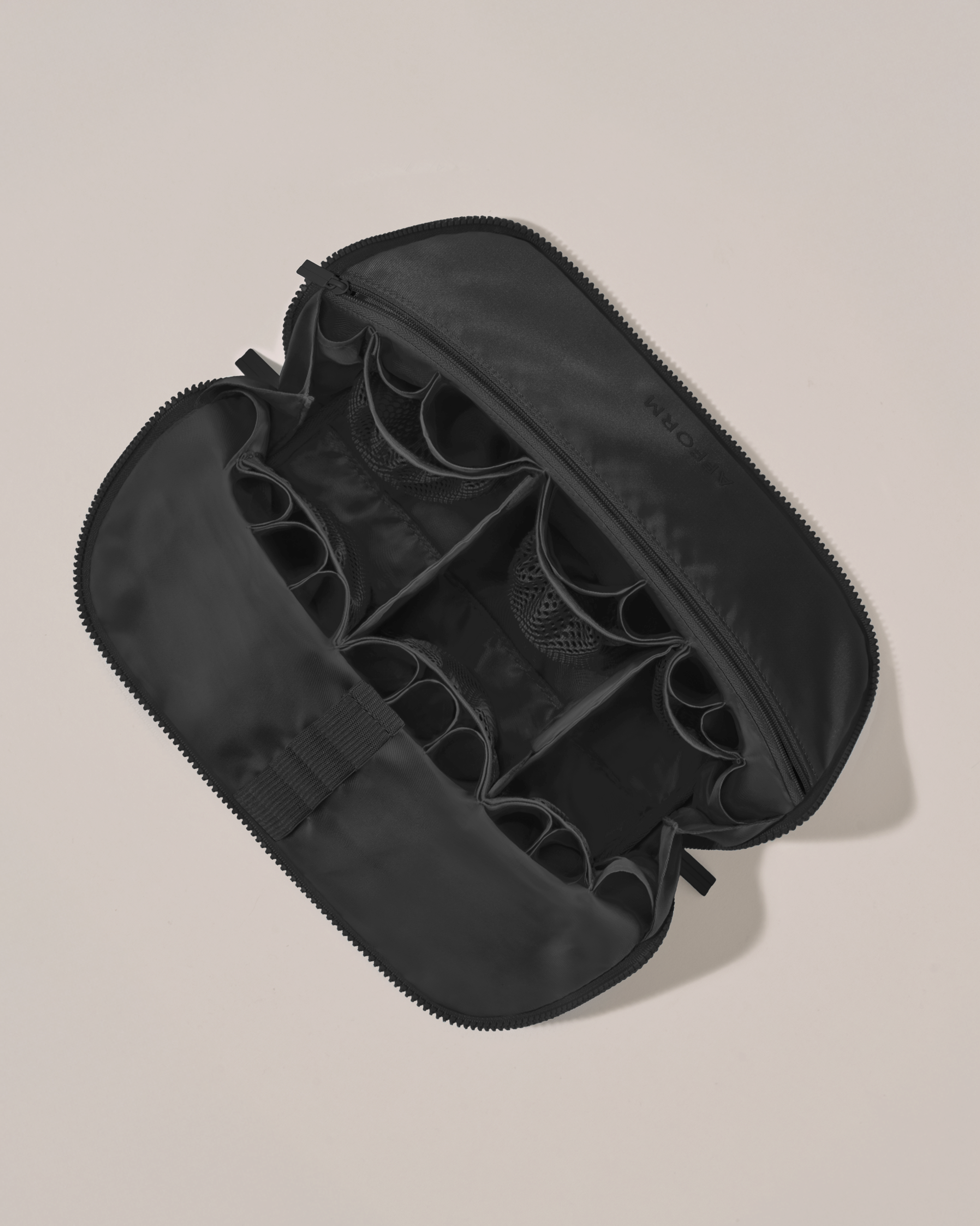 Interior view of Afform Large Onyx (black) Traveller makeup bag showing empty pockets, pouches, elastic holders, and zipper pocket for loose items