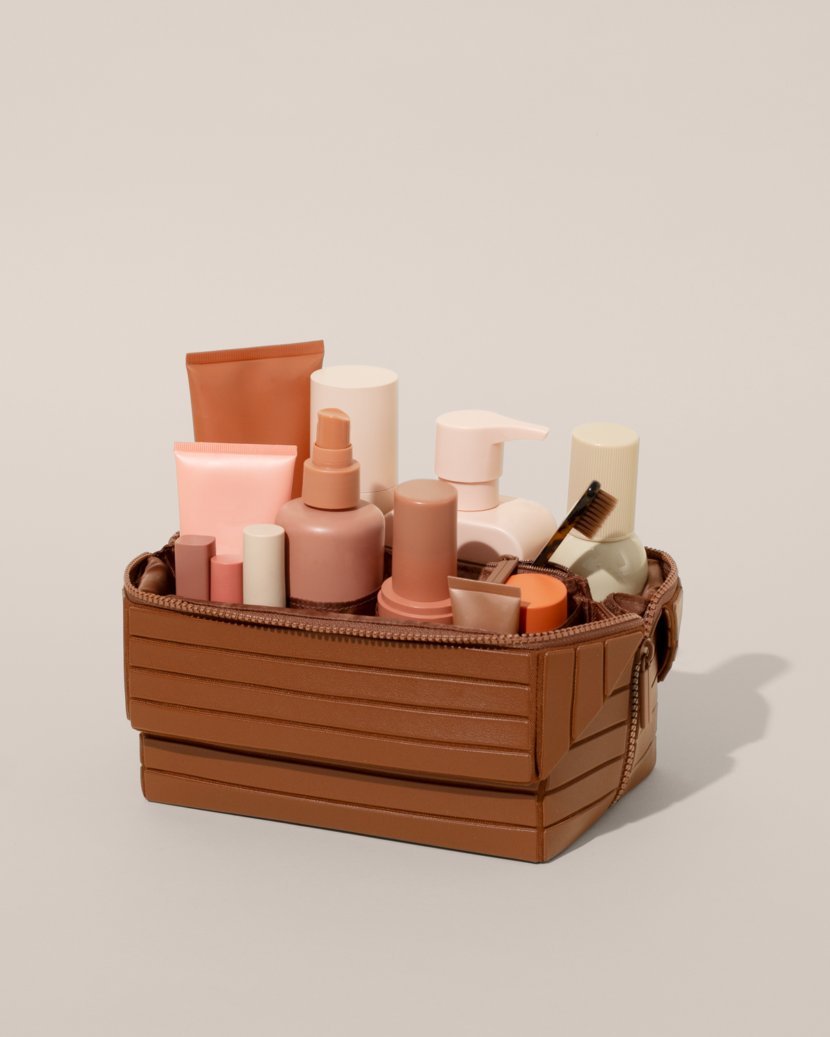 Open Afform Vicuna (brown) Kit, shown open and packed with skincare and grooming products. A compact, structured toiletry bag designed for visibility and access.
