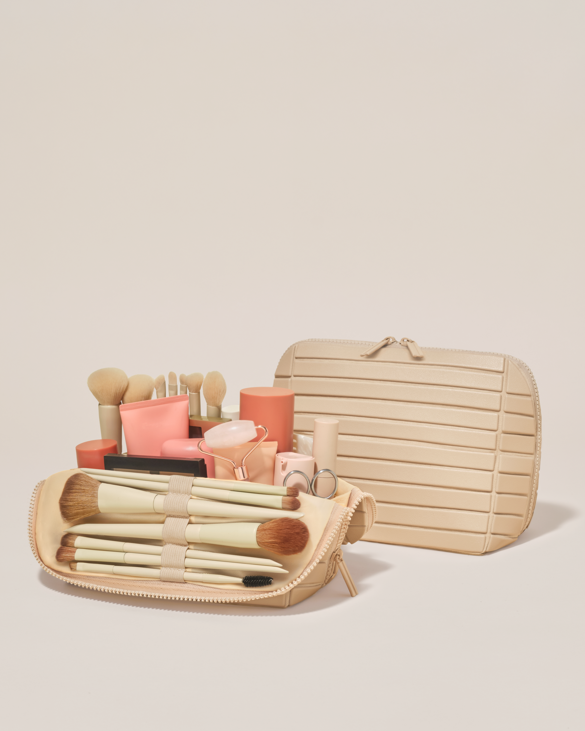 Open and closed Afform Medium Bisque (white) Traveller makeup bag showing skincare, brushes, and curated travel essentials