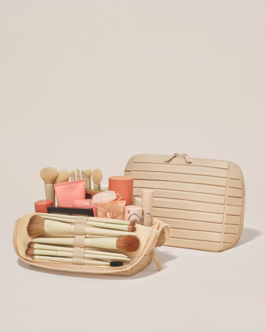 Open and closed Afform Medium Bisque (white) Traveller makeup bag showing skincare, brushes, and curated travel essentials