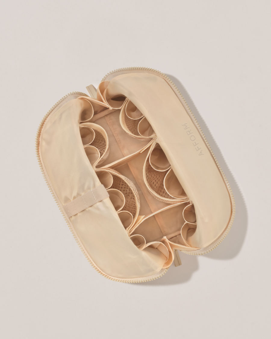 Interior view of Afform Medium Bisque (white) Traveller makeup bag showing empty pockets, pouches, and elastic holders