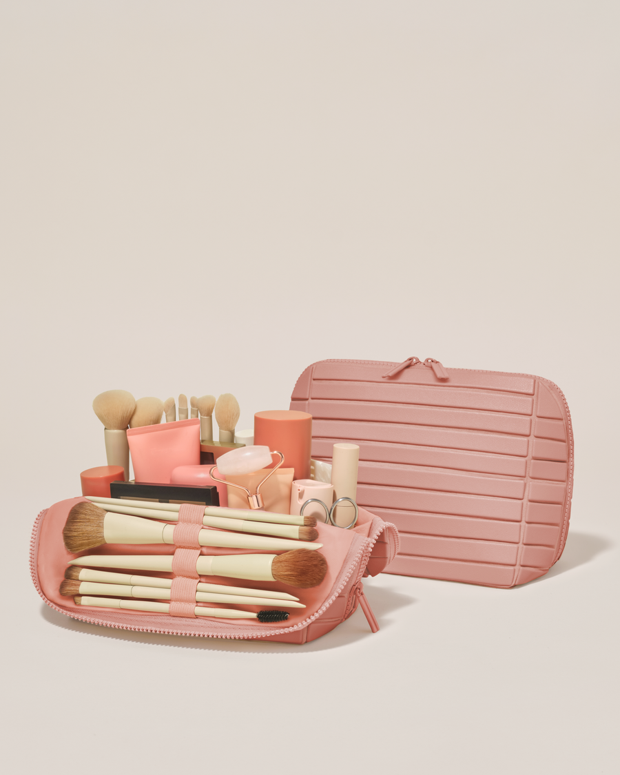 Open and closed Afform Medium Blush (pink) Traveller makeup bag showing skincare, brushes, and curated travel essentials