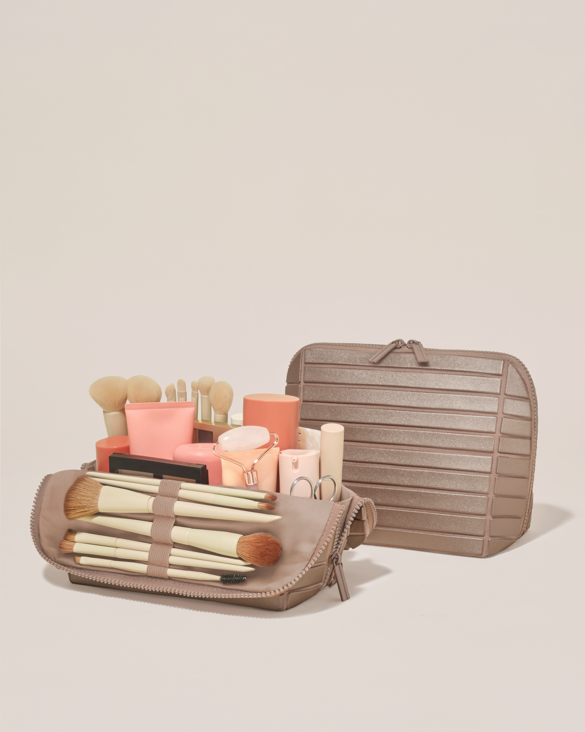 Open and closed Afform Medium Bronze Traveller makeup bag showing skincare, brushes, and curated travel essentials