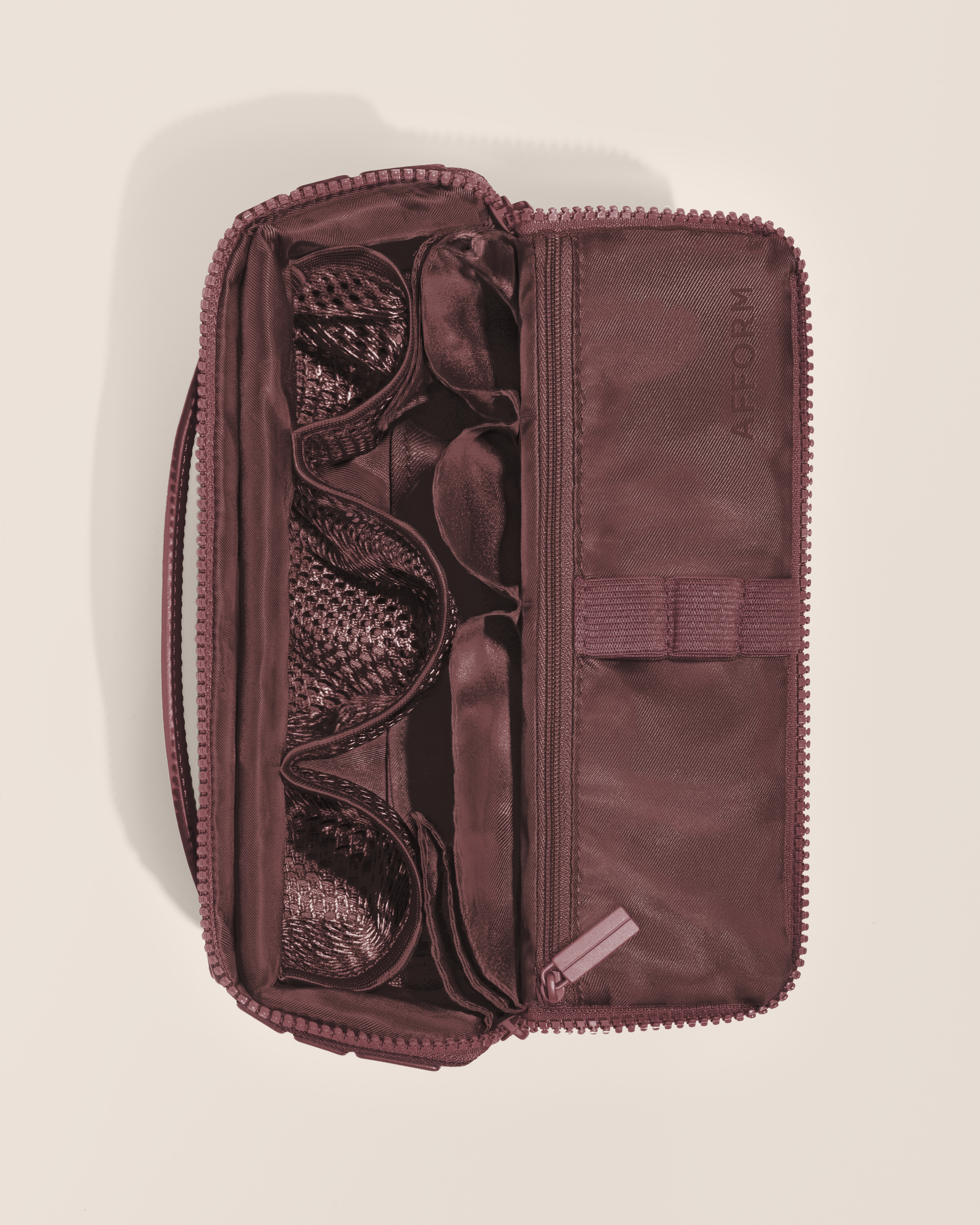 Overhead view of Afform Medium Cassis (maroon) Kit toiletry bag, showcasing its structured interior with multiple compartments and mesh pockets for organized travel storage