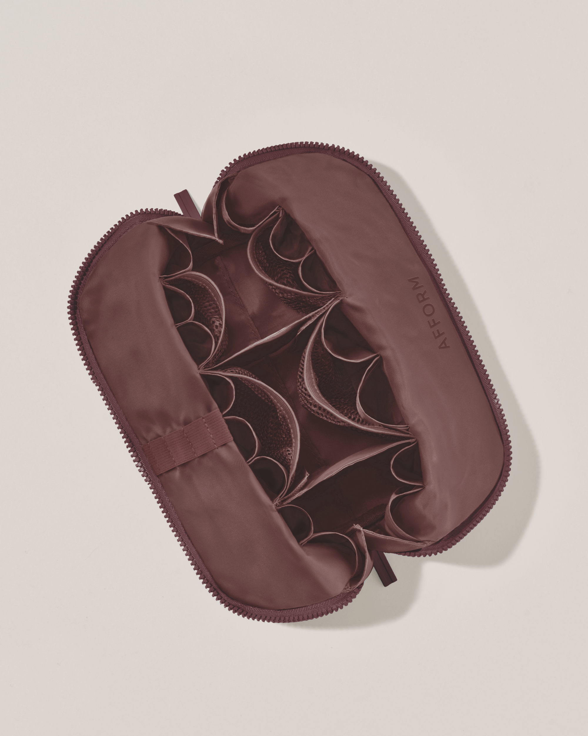 Interior view of Afform Medium Cassis (maroon) Traveller makeup bag showing empty pockets, pouches, and elastic holders