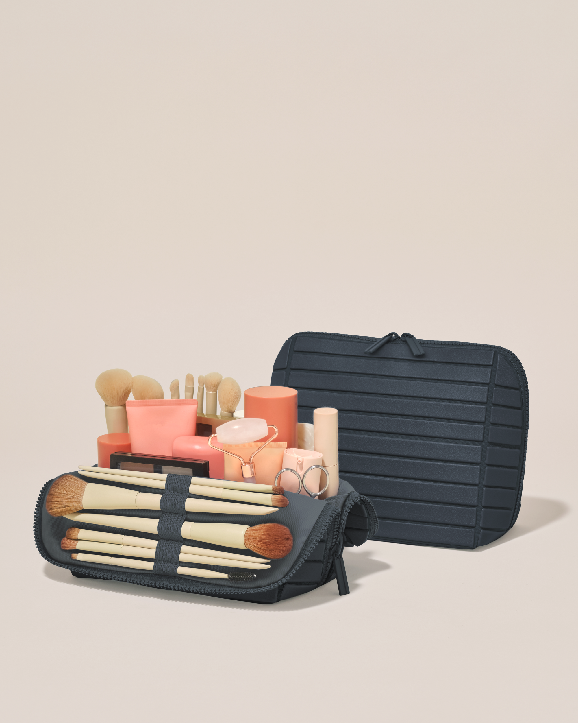 Open and closed Afform Medium Indigo (navy) Traveller makeup bag showing skincare, brushes, and curated travel essentials