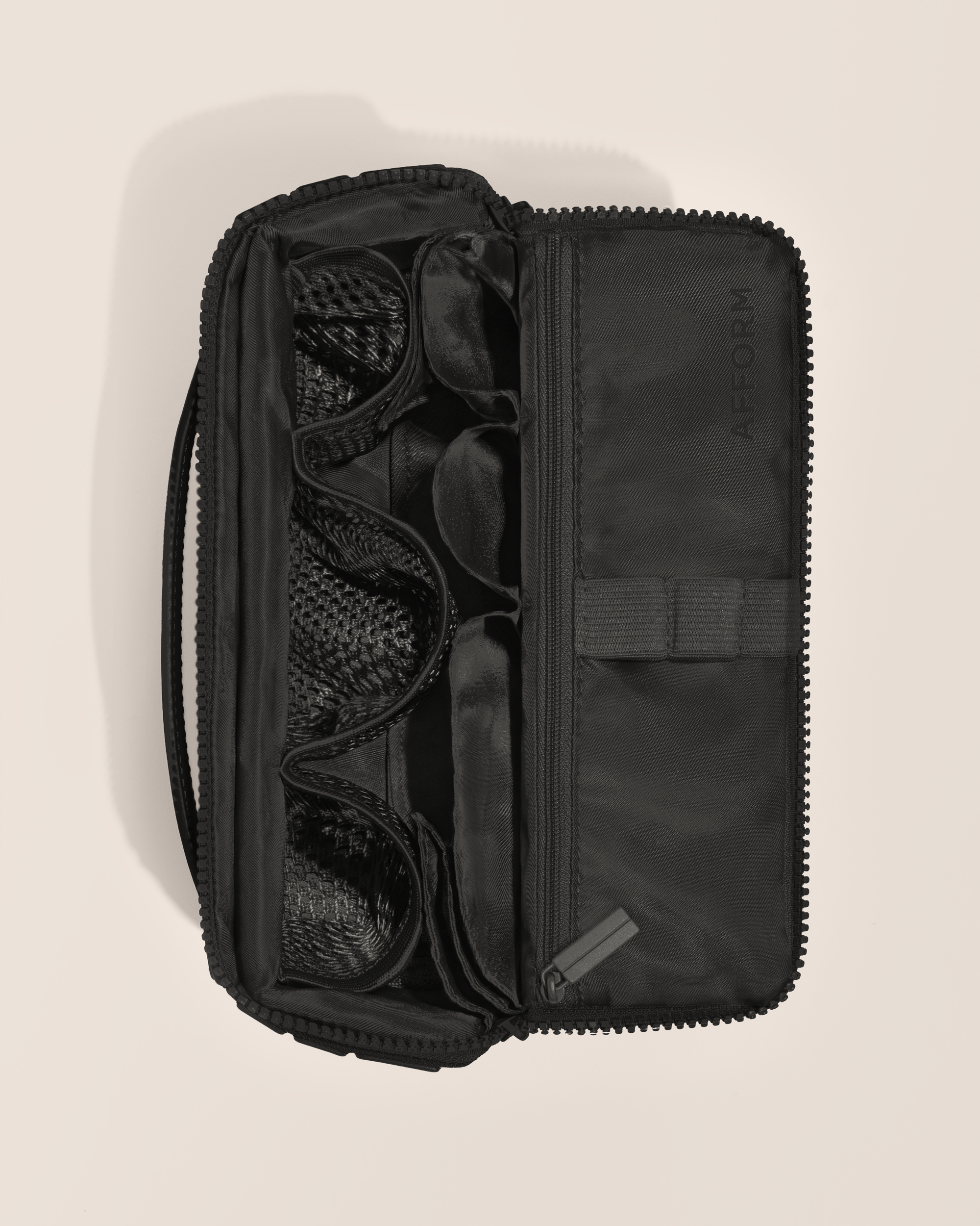 Overhead view of Afform Medium Onyx (black) Kit toiletry bag, showcasing its structured interior with multiple compartments and mesh pockets for organized travel storage