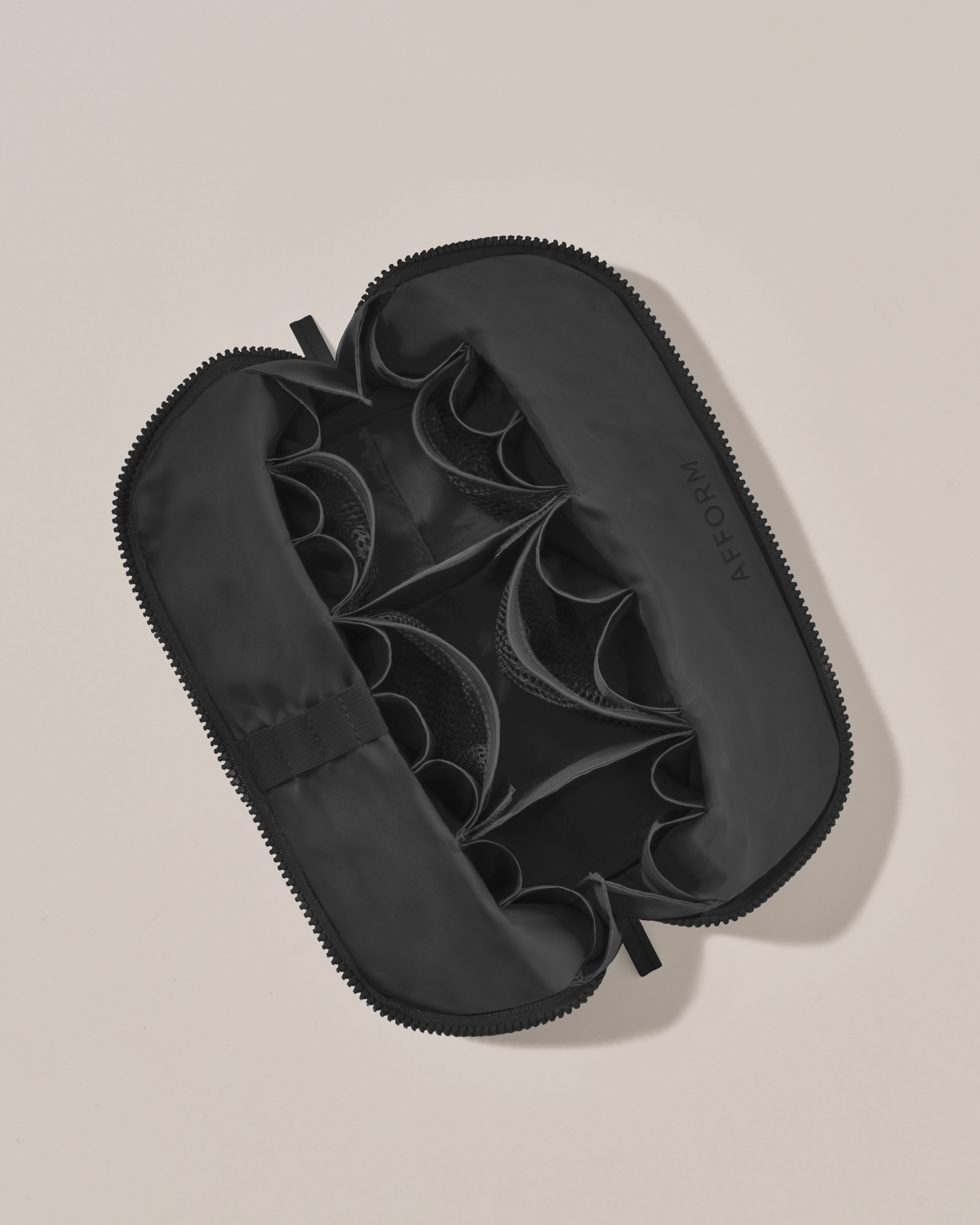 Interior view of Afform Medium Onyx (black) Traveller makeup bag showing empty pockets, pouches, and elastic holders