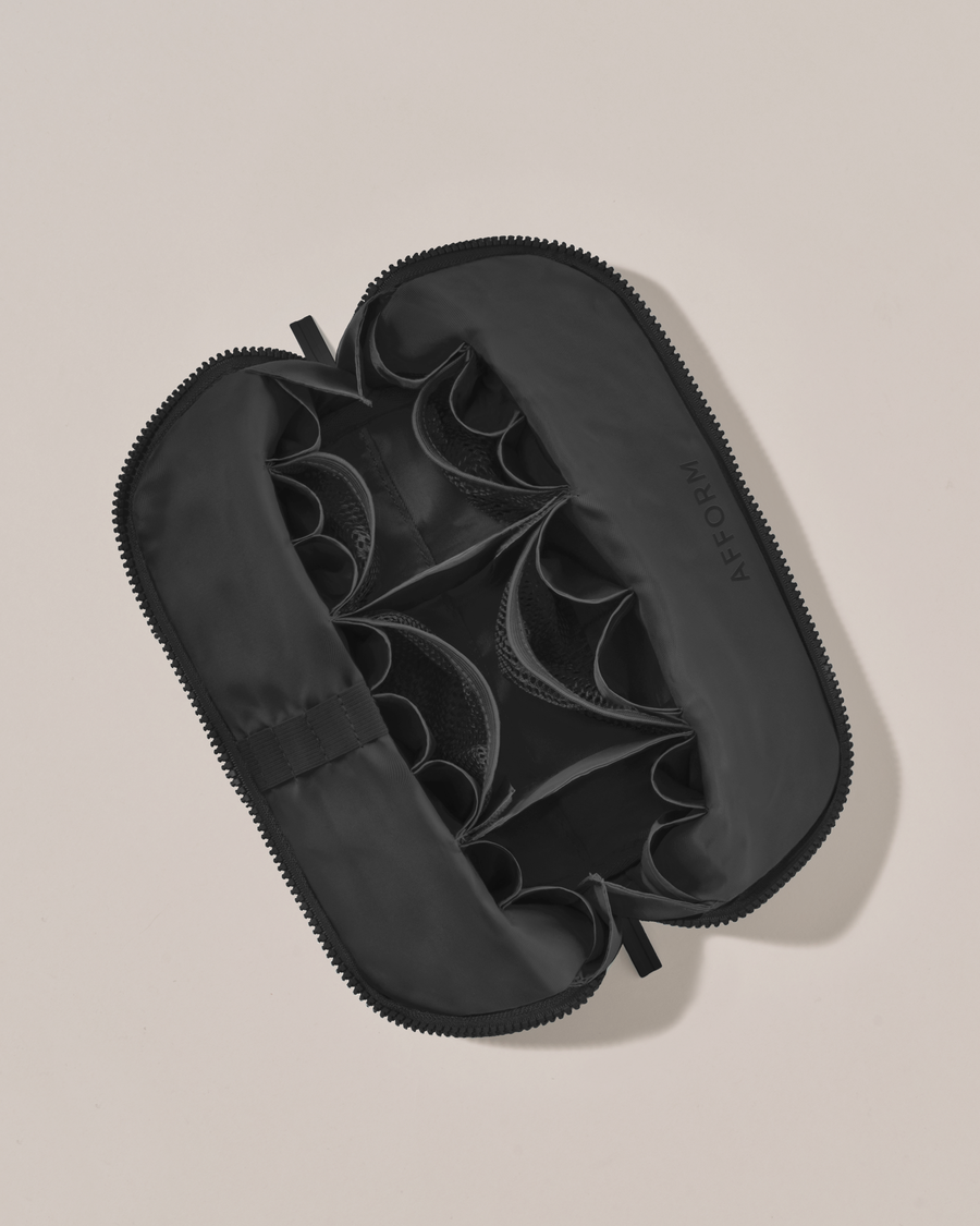 Interior view of Afform Medium Onyx (black) Traveller makeup bag showing empty pockets, pouches, and elastic holders