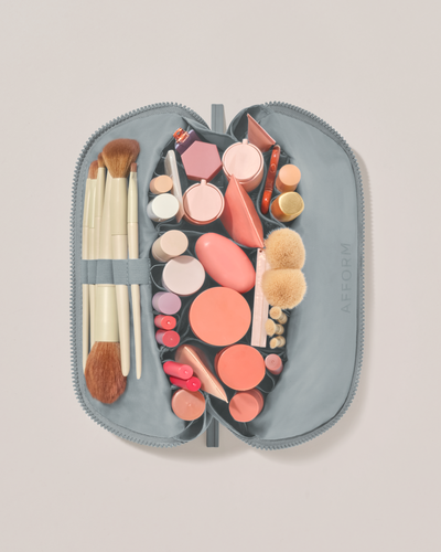 Image of the medium traveller  top down, open with an assortment of products inside of it.