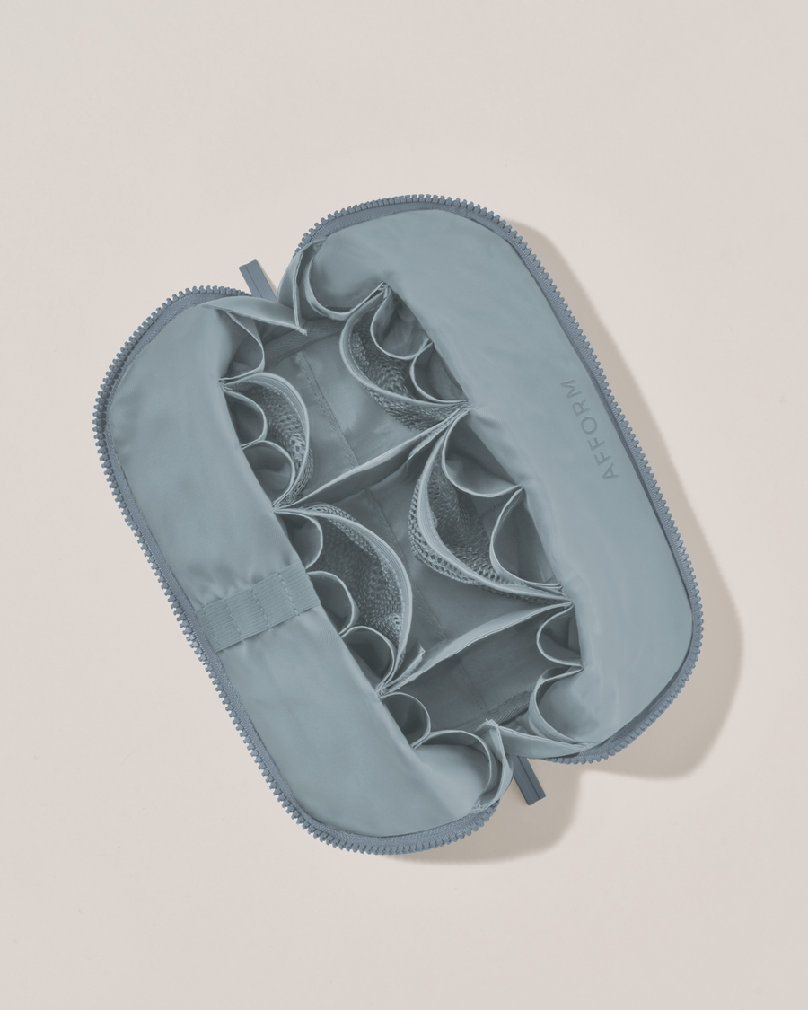 Interior view of Afform Medium Slate (blue) Traveller makeup bag showing empty pockets, pouches, and elastic holders