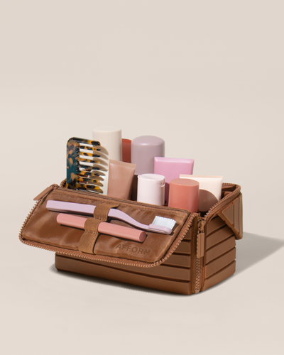 Image of the medium kit top, open with an assortment of toiletries inside of it.