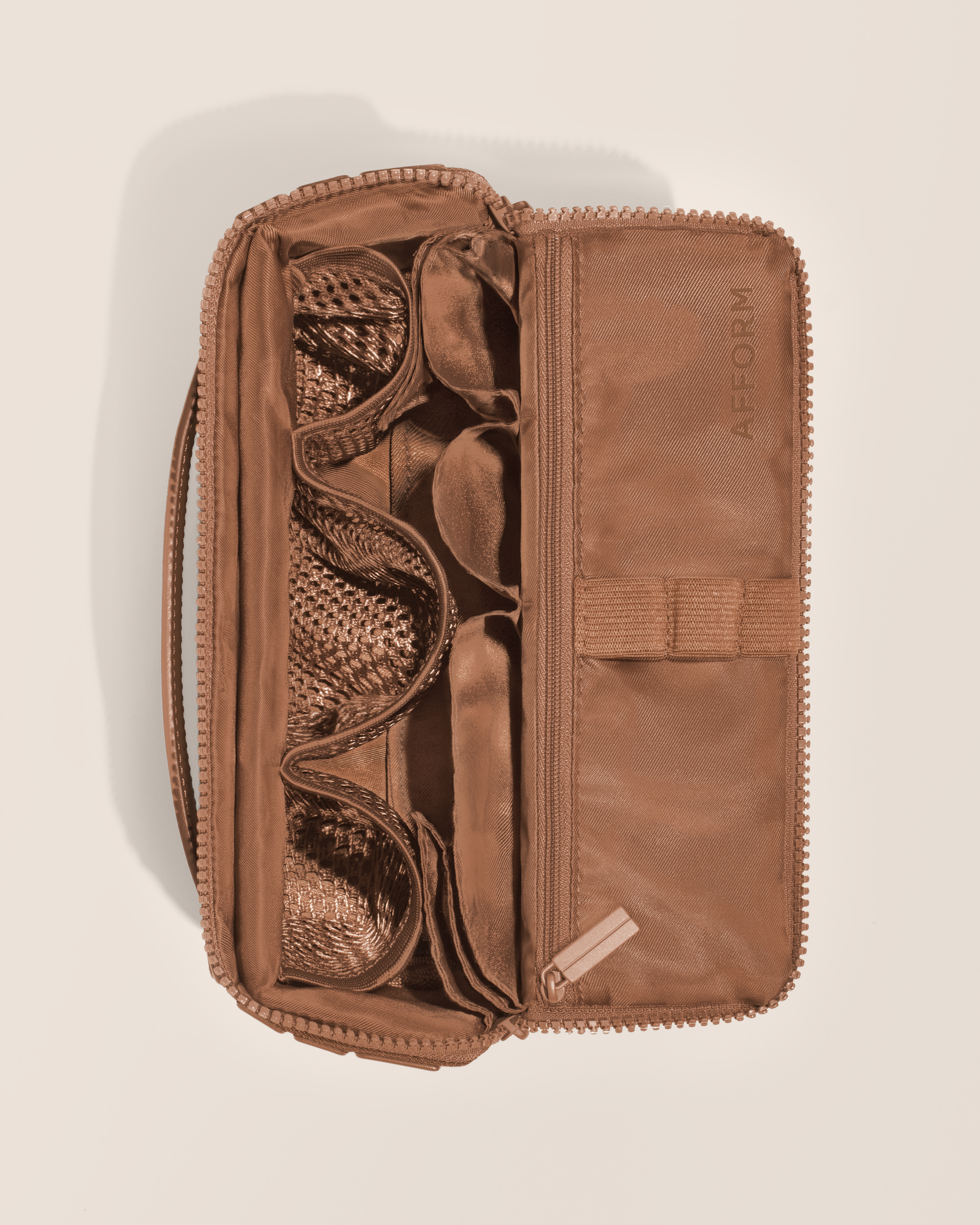 Overhead view of Afform Medium Vicuna (brown) Kit toiletry bag, showcasing its structured interior with multiple compartments and mesh pockets for organized travel storage