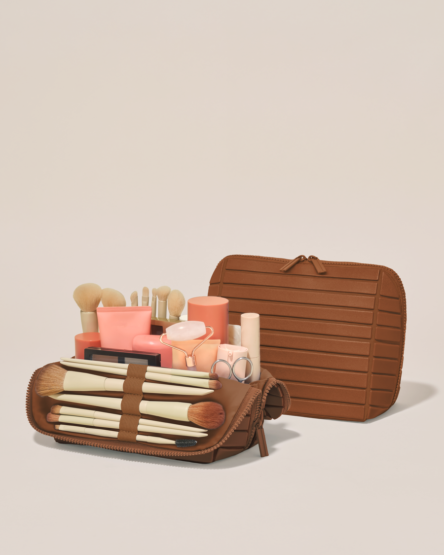 Open and closed Afform Medium Vicuna (brown) Traveller makeup bag showing skincare, brushes, and curated travel essentials