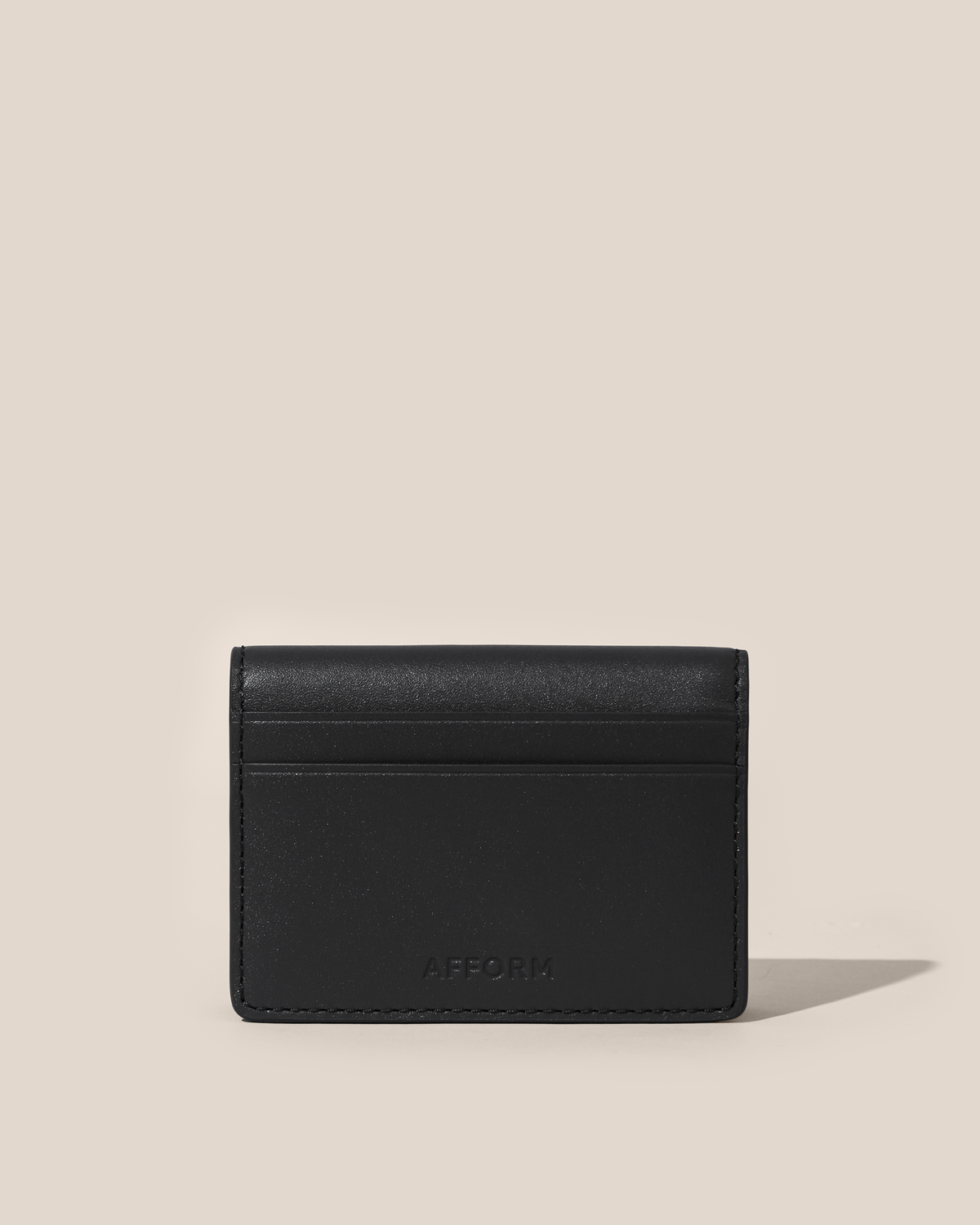 Back of the Afform Onyx Card Case showing an exterior slip pocket and embossed Afform logo
