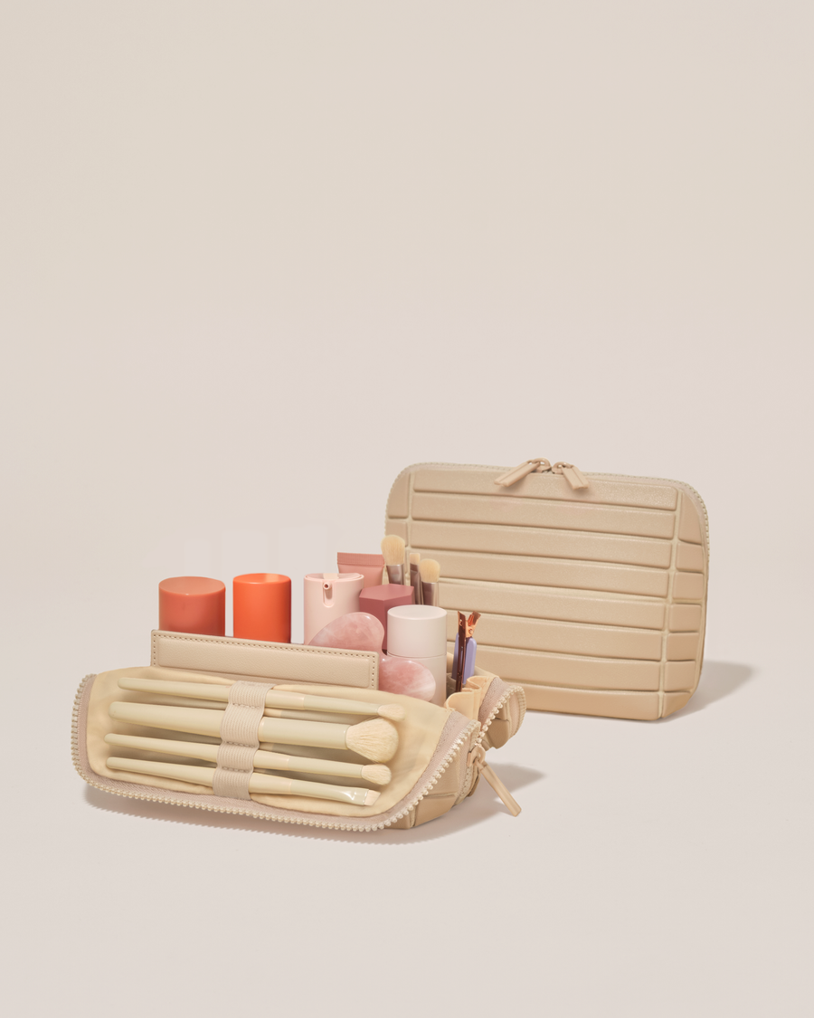 Open and closed Afform Small Bisque (white) Traveller makeup bag showing skincare, brushes, and curated travel essentials