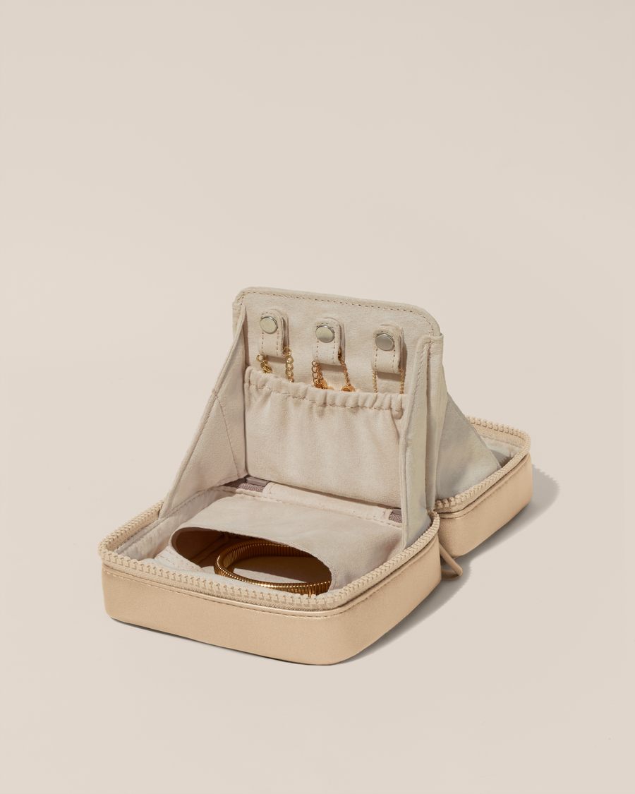Open Afform Small Bisque (white) Vault, shown open and packed with necklaces in dedicated necklace pouches with snaps to keep them in place. Bracelets are packed in a zipper pocket.