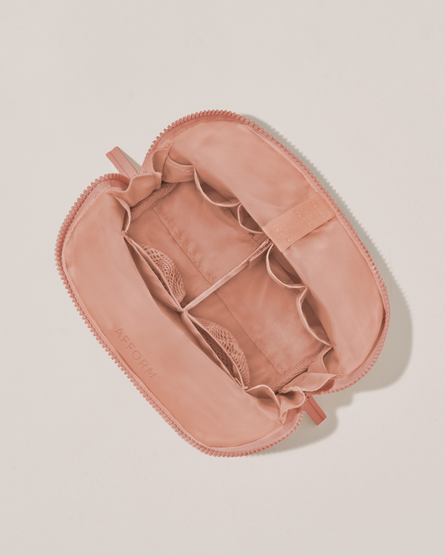 Interior view of Afform Small Blush (pink) Traveller makeup bag showing empty pockets, pouches, and elastic holders