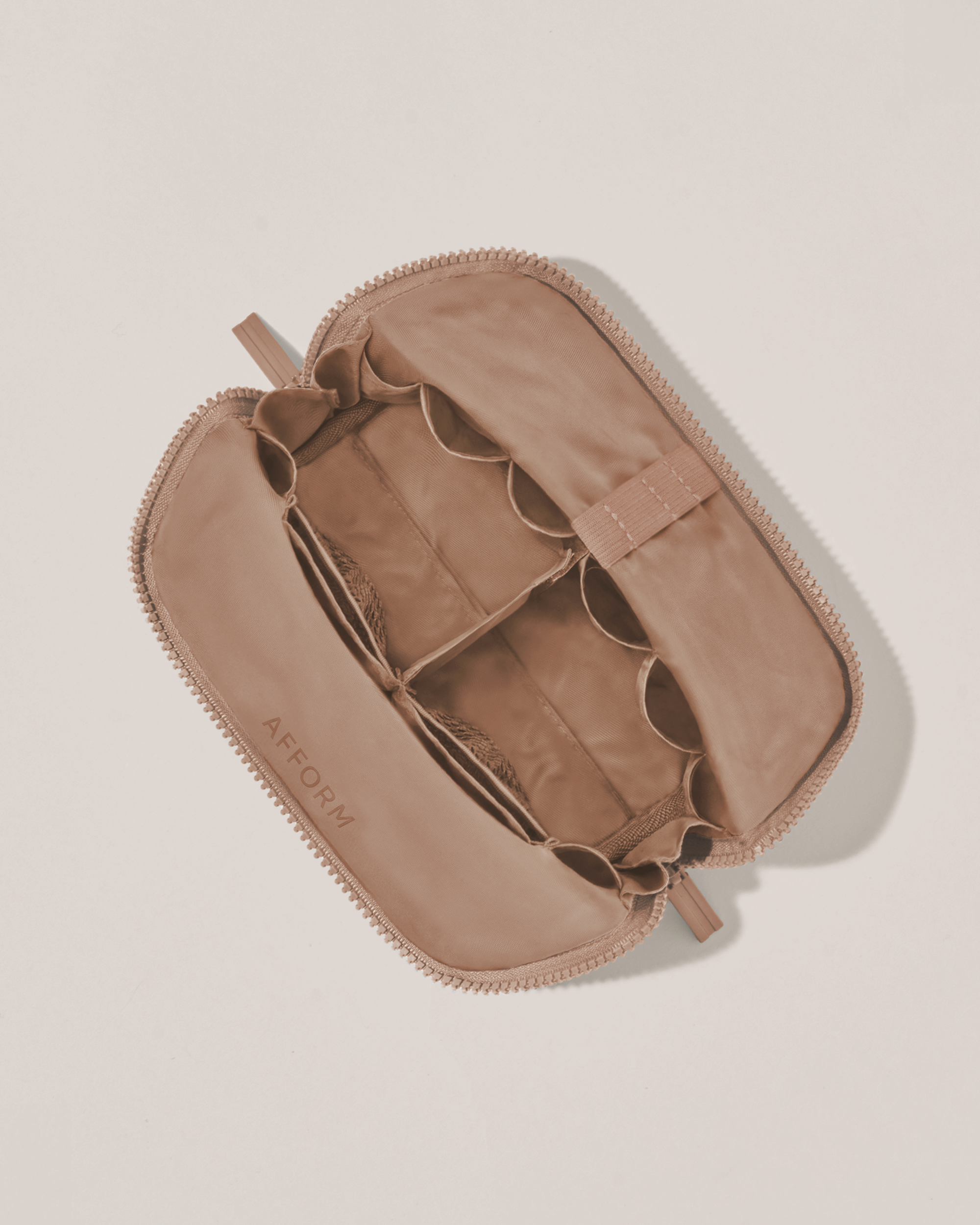 Interior view of Afform Small Bronze Traveller makeup bag showing empty pockets, pouches, and elastic holders