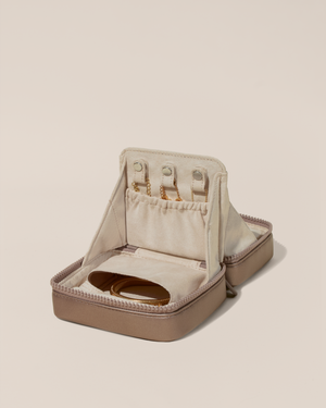 Image of the small vault open showing it holds 3 necklaces and a bracelet on one side.