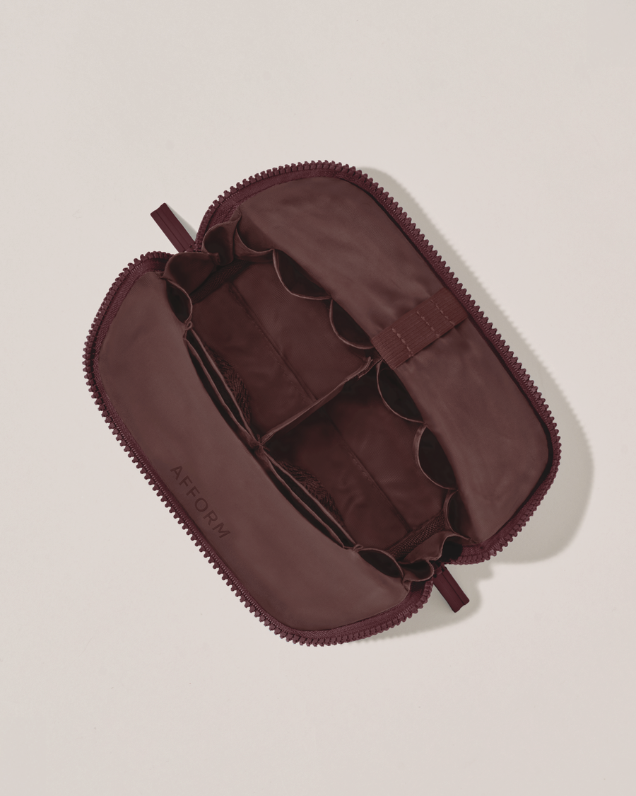 Interior view of Afform Small Cassis (maroon) Traveller makeup bag showing empty pockets, pouches, and elastic holders