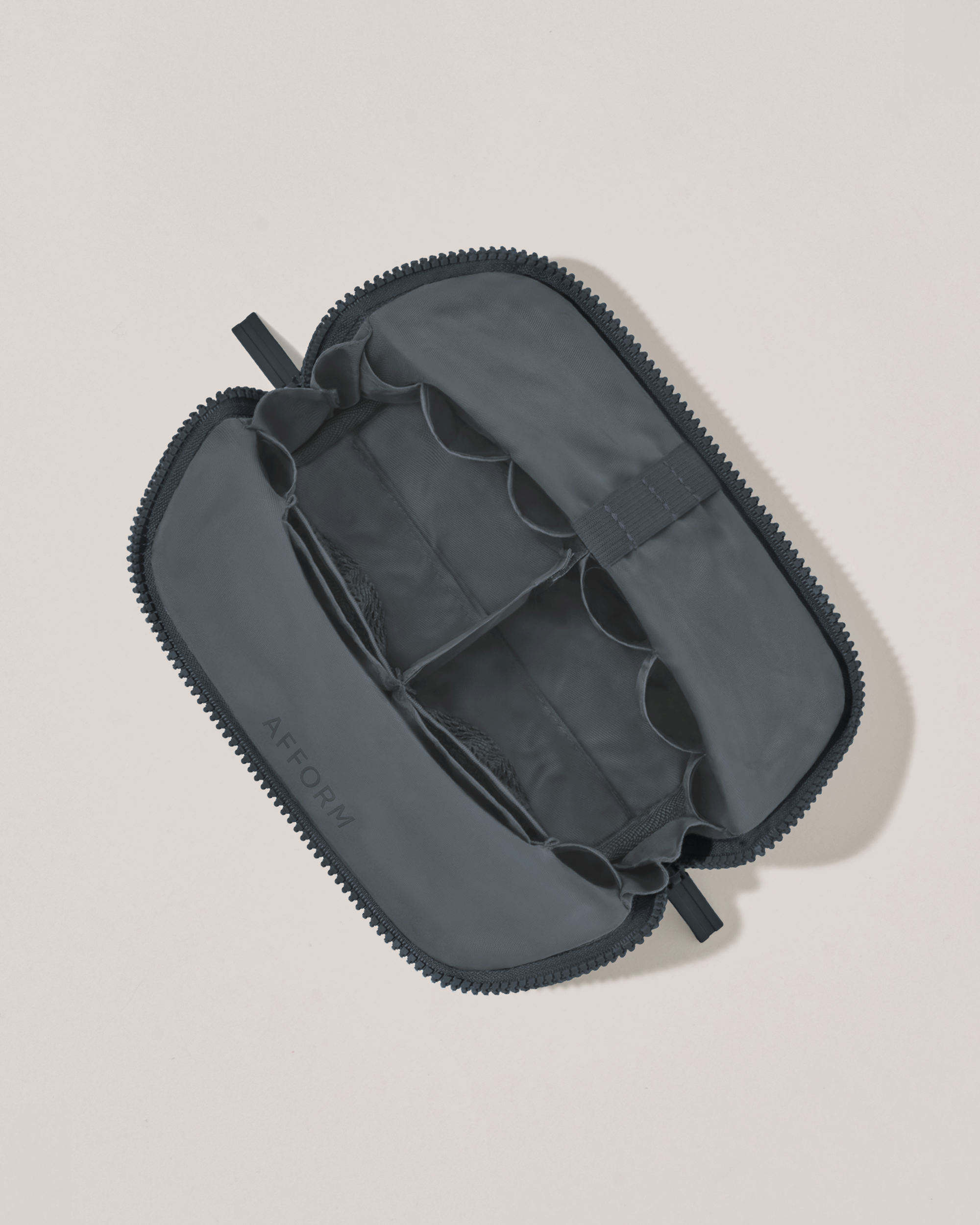 Interior view of Afform Small Indigo (navy) Traveller makeup bag showing empty pockets, pouches, and elastic holders